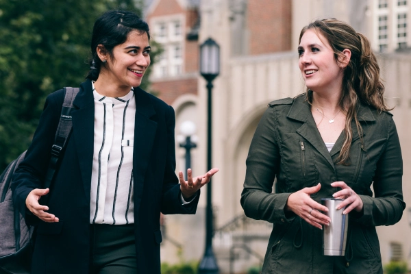 two graduate students walking together