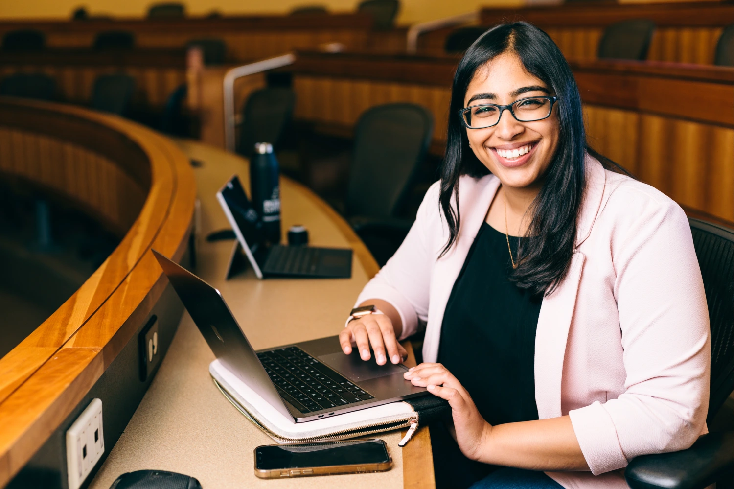 Student smiling with open laptop