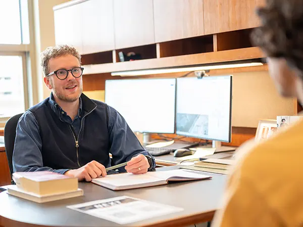 A career advisor works with a student