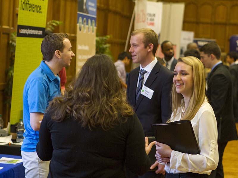Students and recruiters talking at a career fair