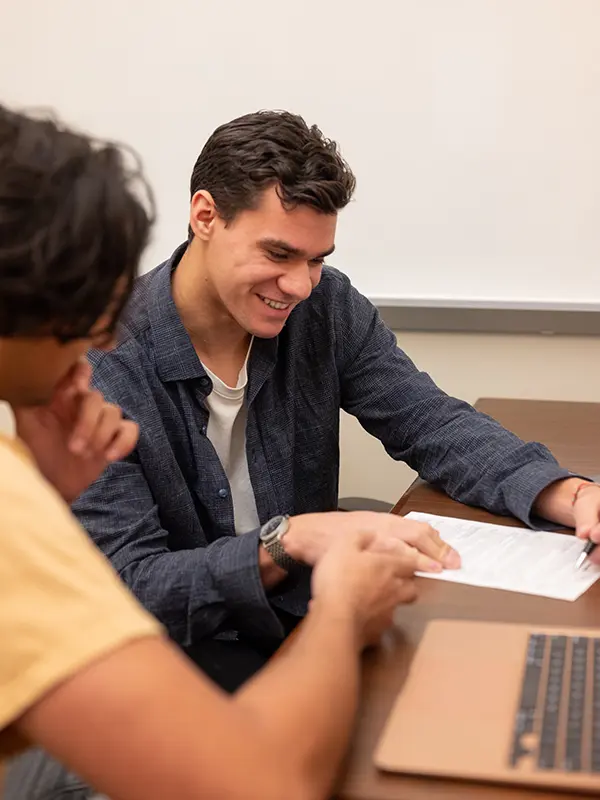A peer consultant works with a student