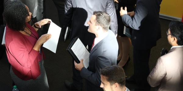 two professionals in conversation at conference