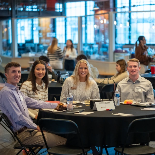 Larsen members seated at table during event