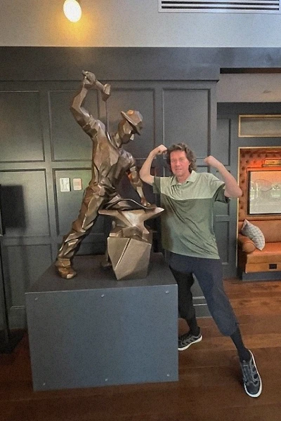 Martin Dufwenberg poses with a bronze boilermaker statue