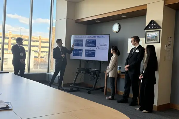 Jensen and his teammates showcasing their proposed solution to the panel of judges.
