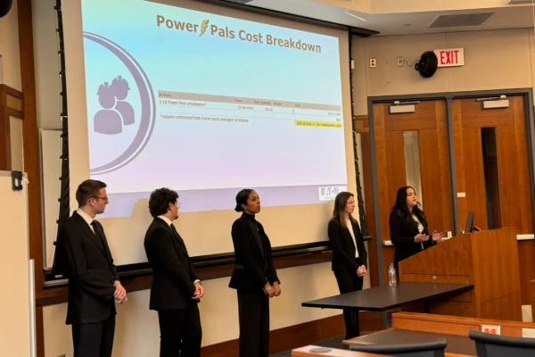 Malaika with team presenting project at conference