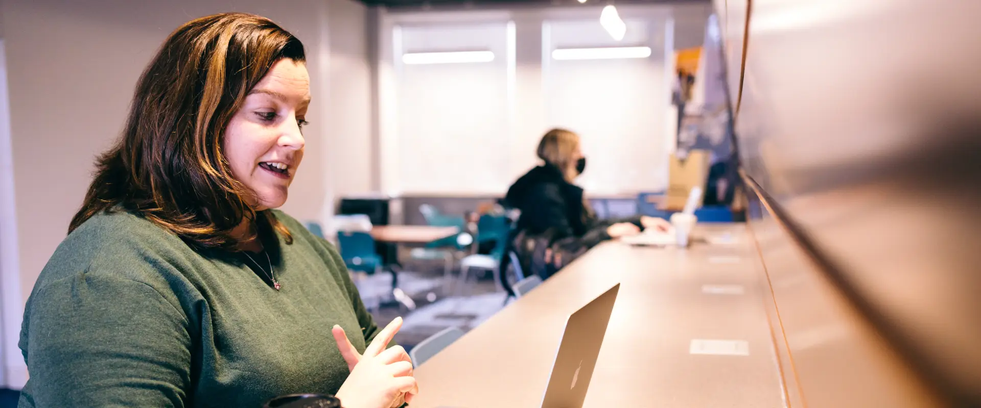 Meredith Simmons having a virtual meeting in the Daniels Business School's drawing room