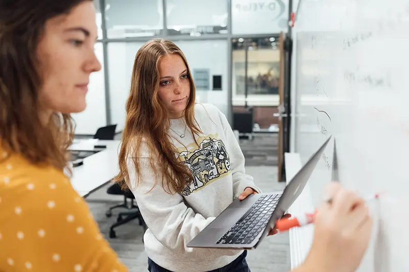 two students work on solving problems