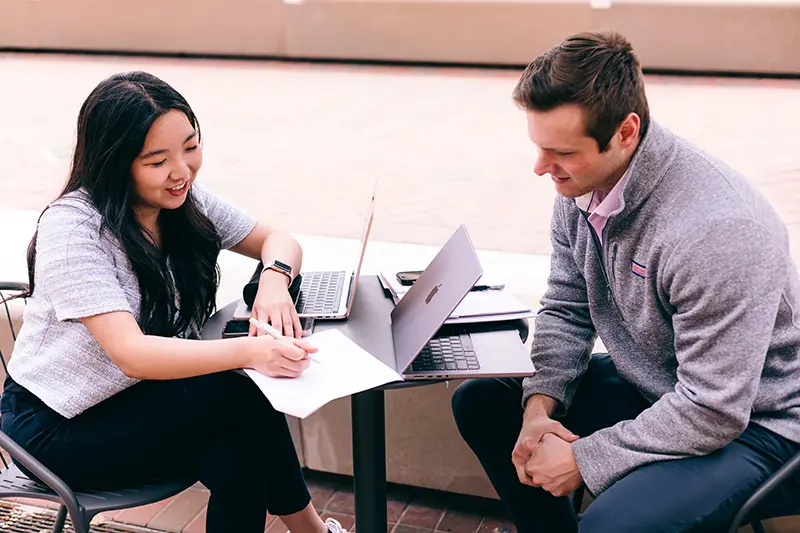 Candid photo of two master's students working together