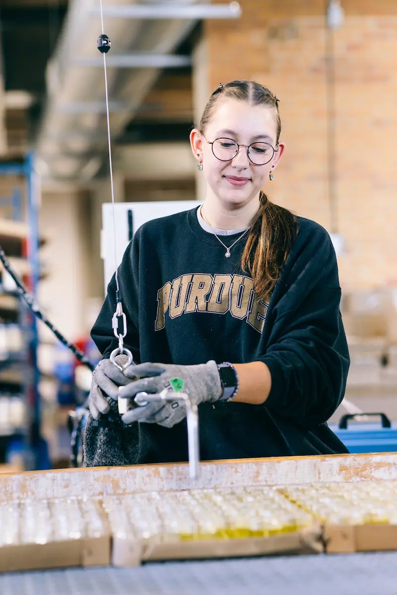 A worker at the Antique Candle Co.
