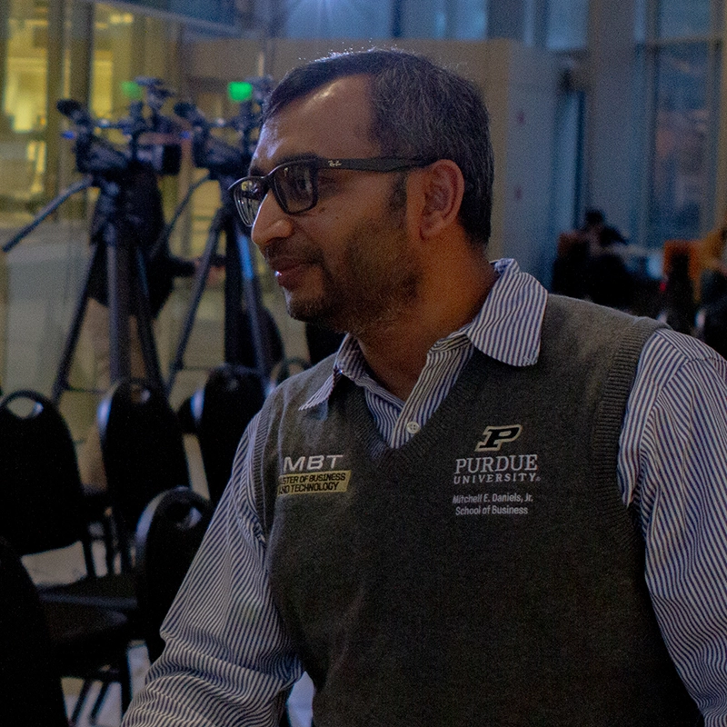 Mohammad Rahman shakes a student's hand