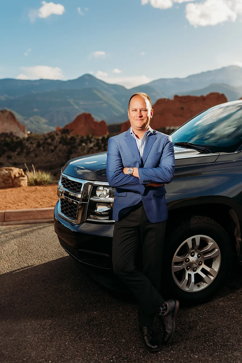 Adam Beal in front of a car