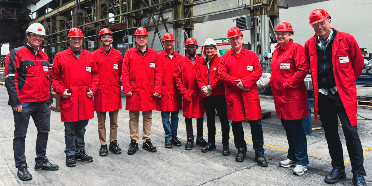 Group wearing PPE at steel plant in Germany