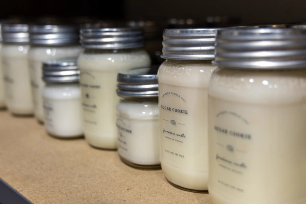 candles sorted by scent on a warehouse shelf