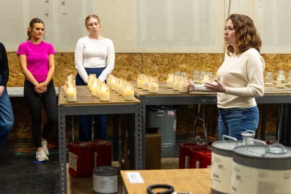 Megan Thompson speaks to students on factory floor tour