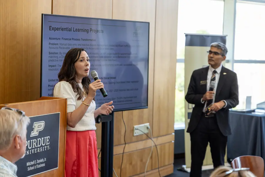 Liz Jackson speaks into microphone at event