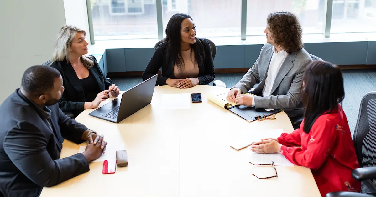 Five people sit at a table