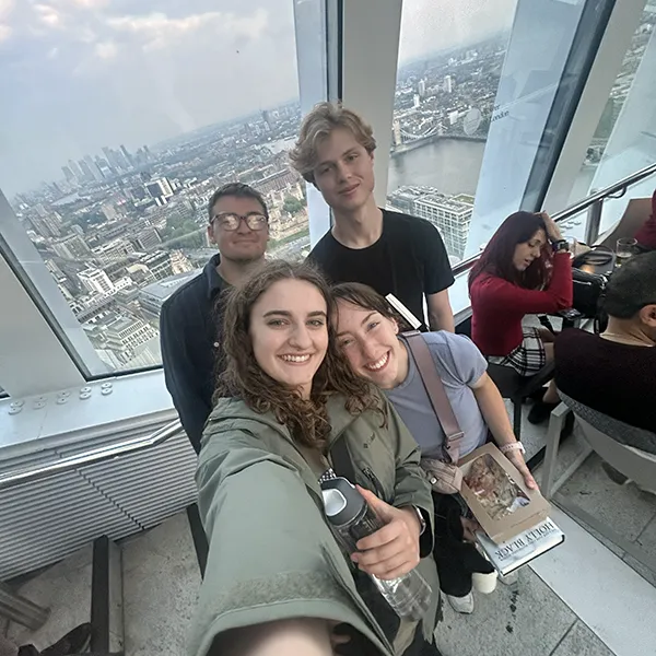 Four students pose at an observation deck in London
